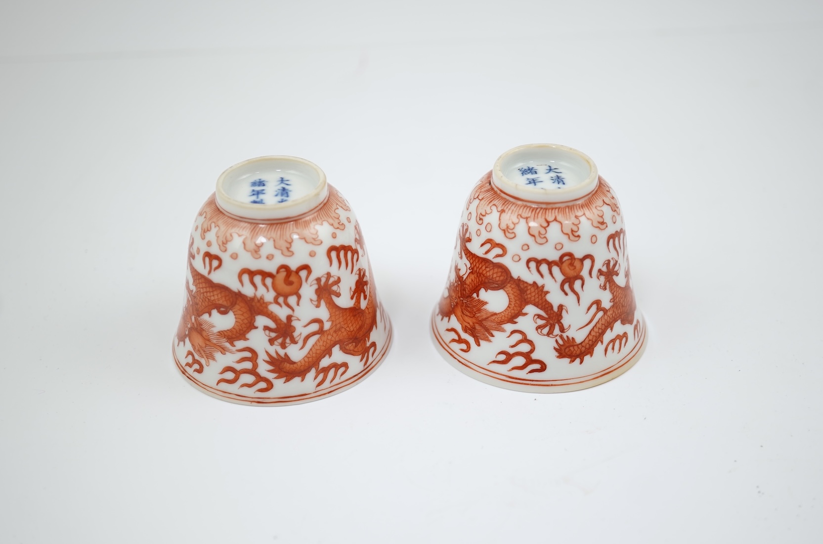 A pair of Chinese iron red ‘dragon’ cups, Guangxu six character mark and probably of the period (1875-1908)